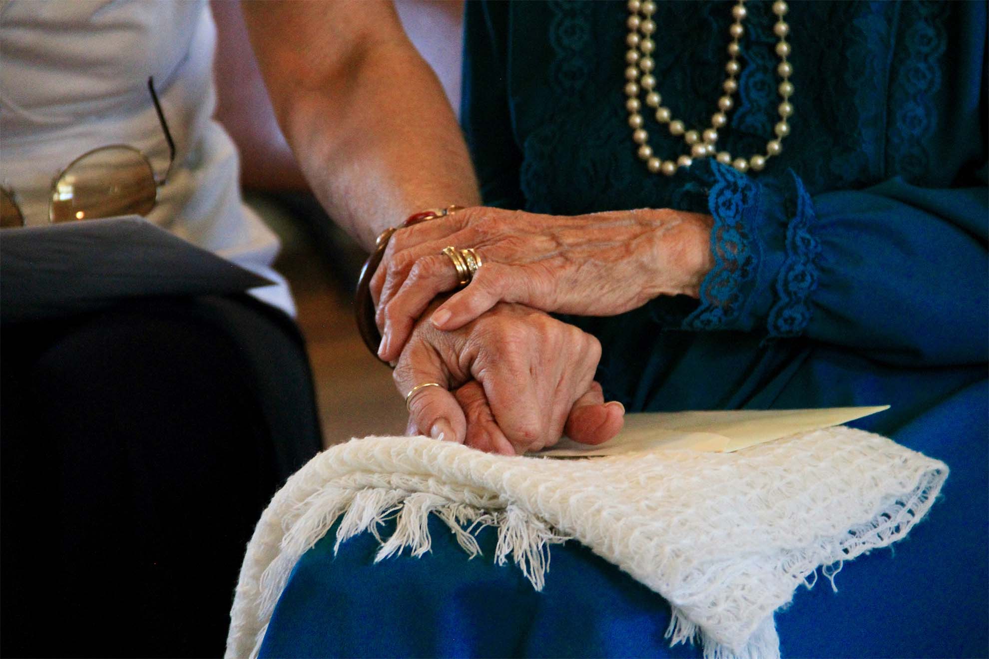 resident holding hands of loved one