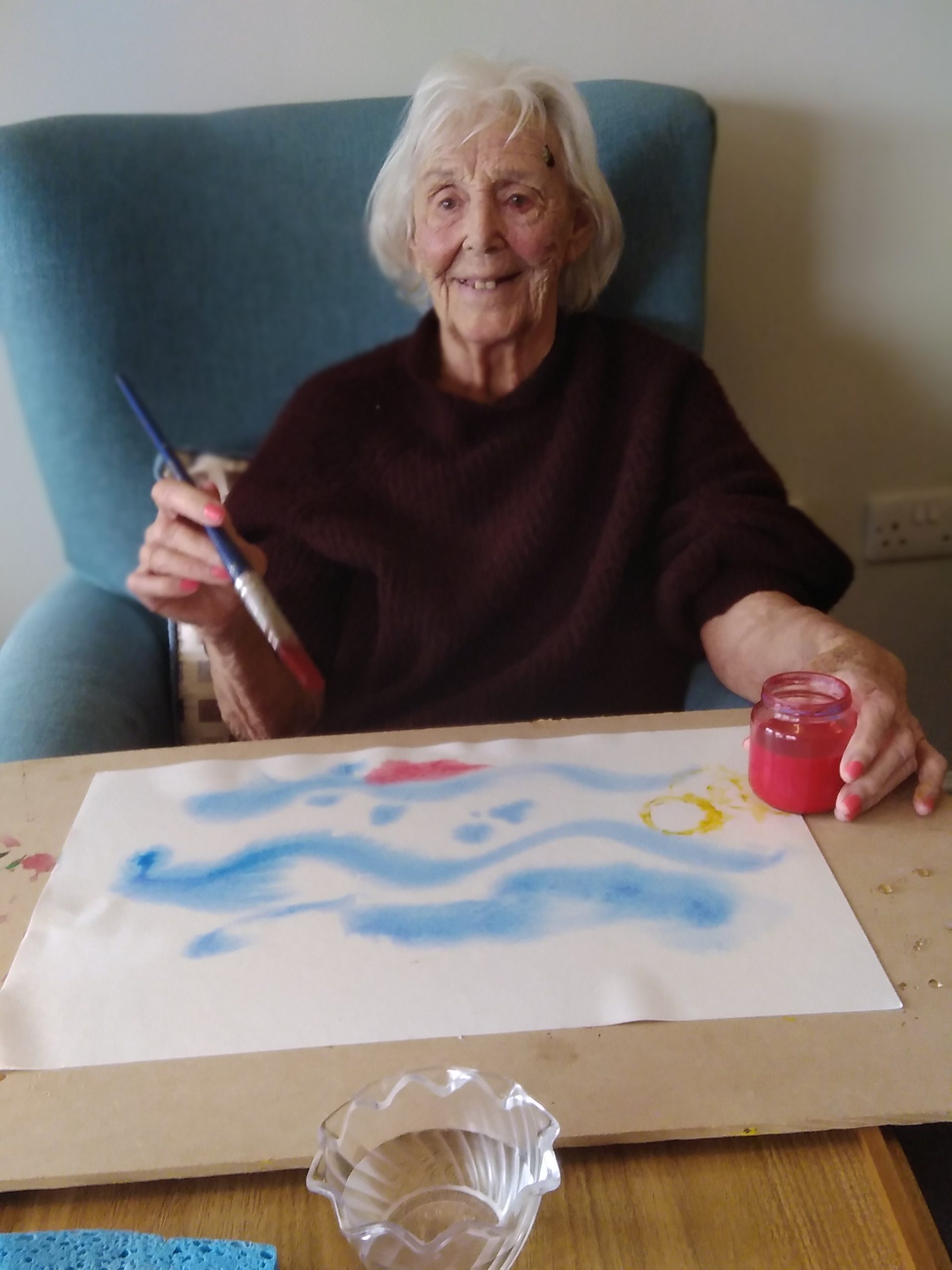 Care home resident enjoying arts and crafts