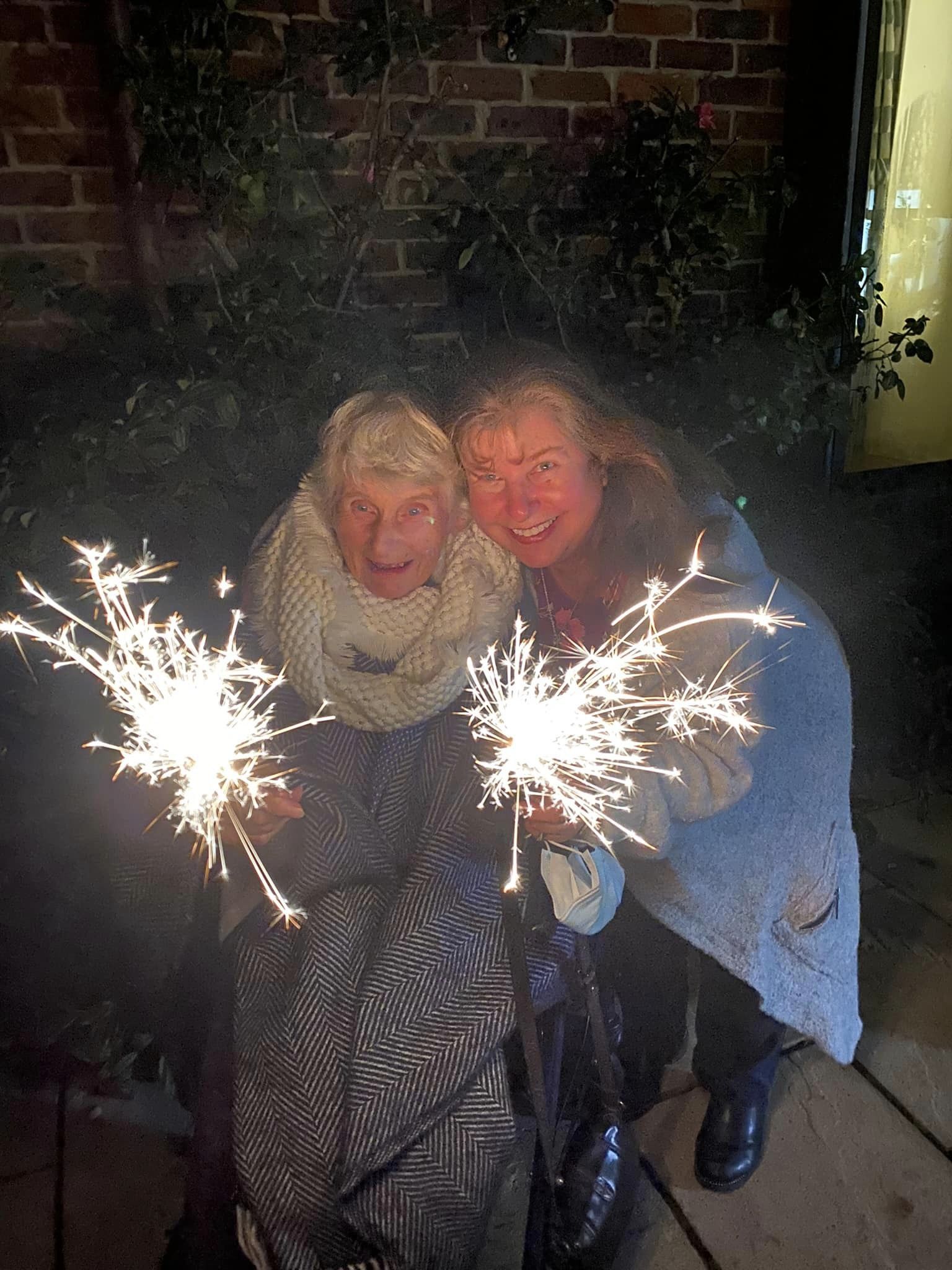 Resident and staff member with sparklers