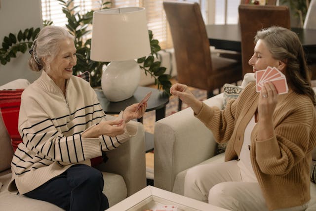 resident and loved one playing cards