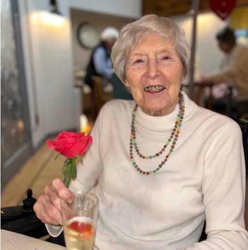 resident celebrating valentines day with a glass of prosecco