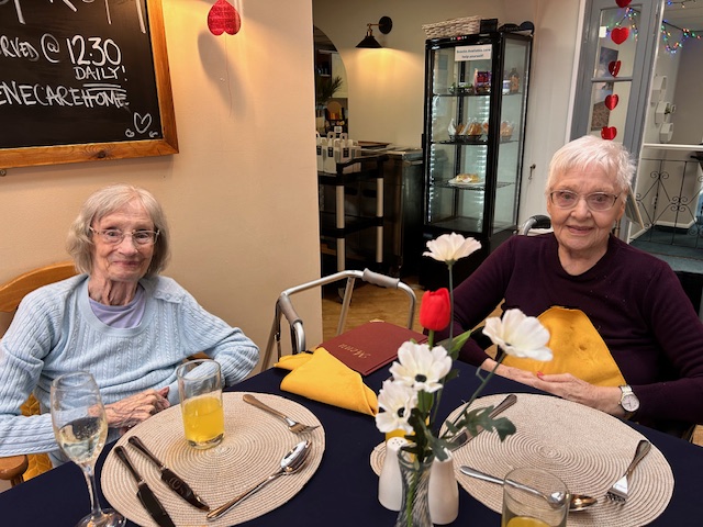 two residents sat together enjoying a valentines lunch