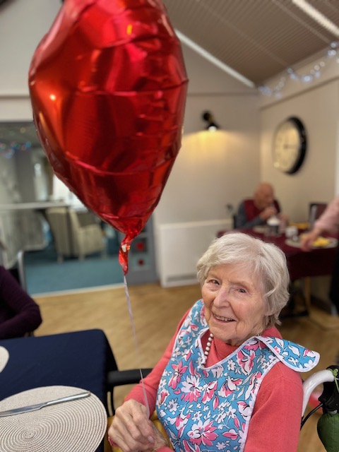 resident sat with balloon heart