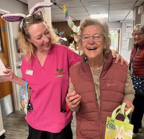 resident smiling doing easter egg hunt