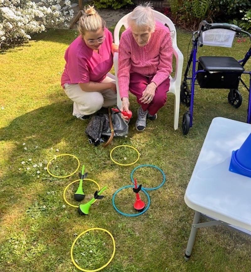 residents doing ring toss with help from a carer