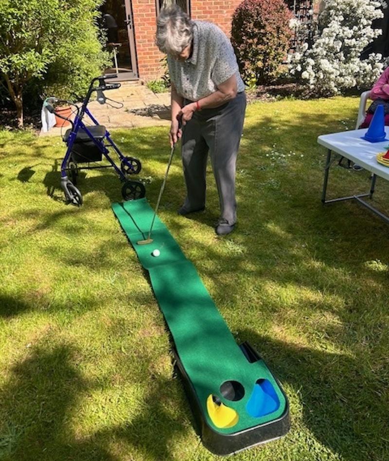 resident playing outdoor golf