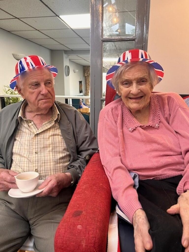 residents sat together in chairs celebrating d day