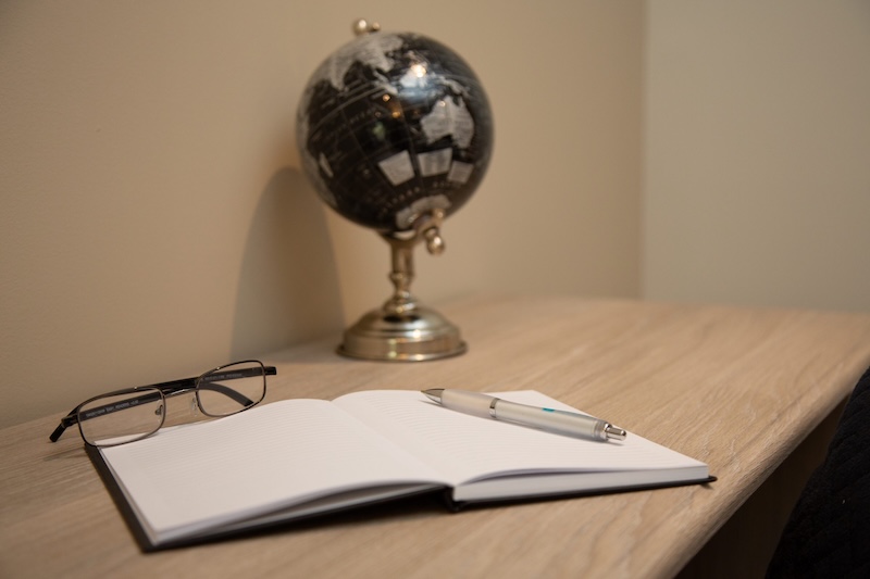 glasses and notebook on desk
