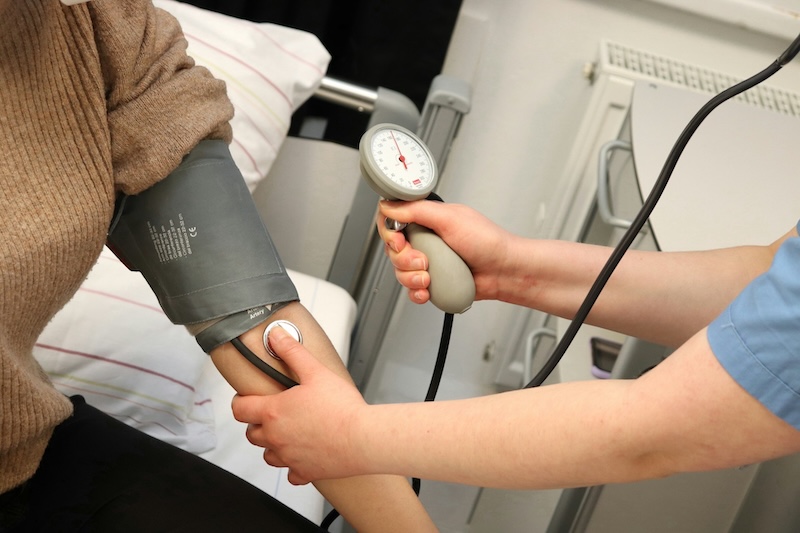 nurse taking blood pressure of a resident