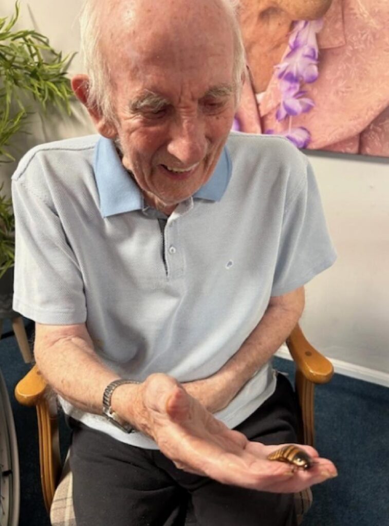 male resident holding a beetle