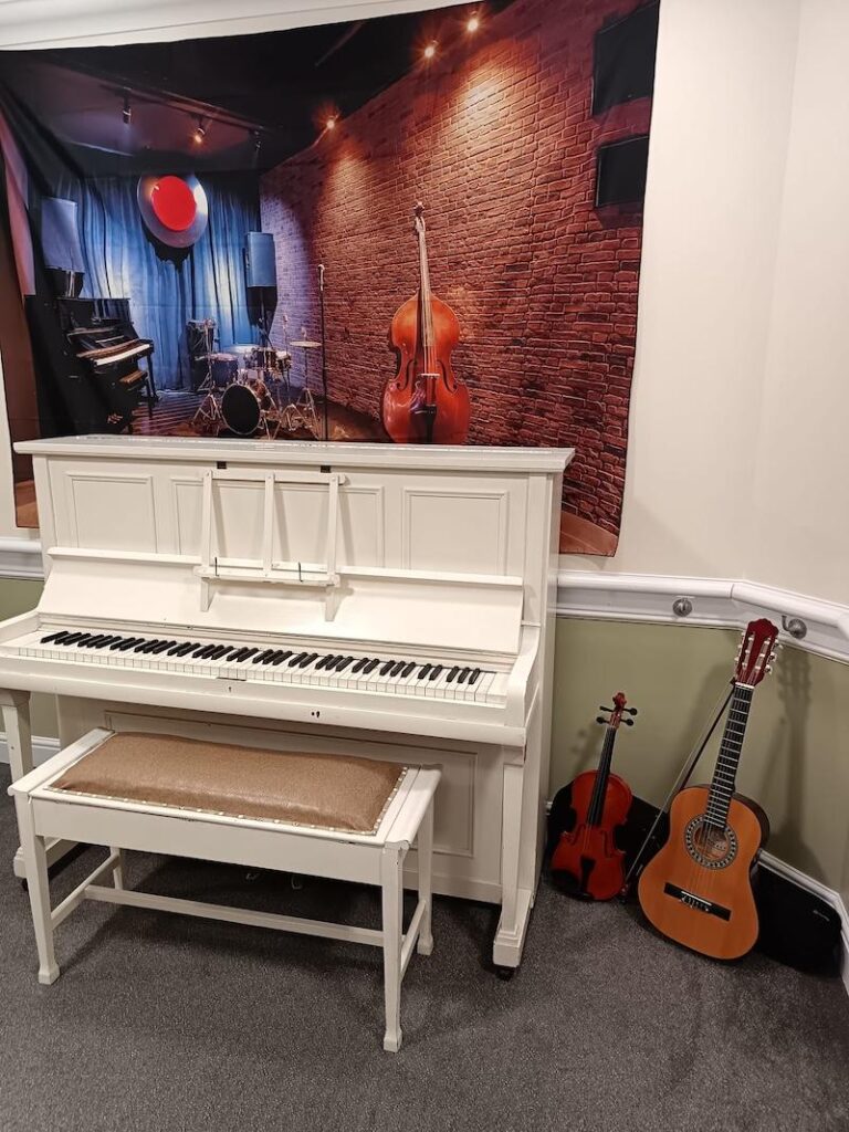 our music corner including a piano, violin and guitar